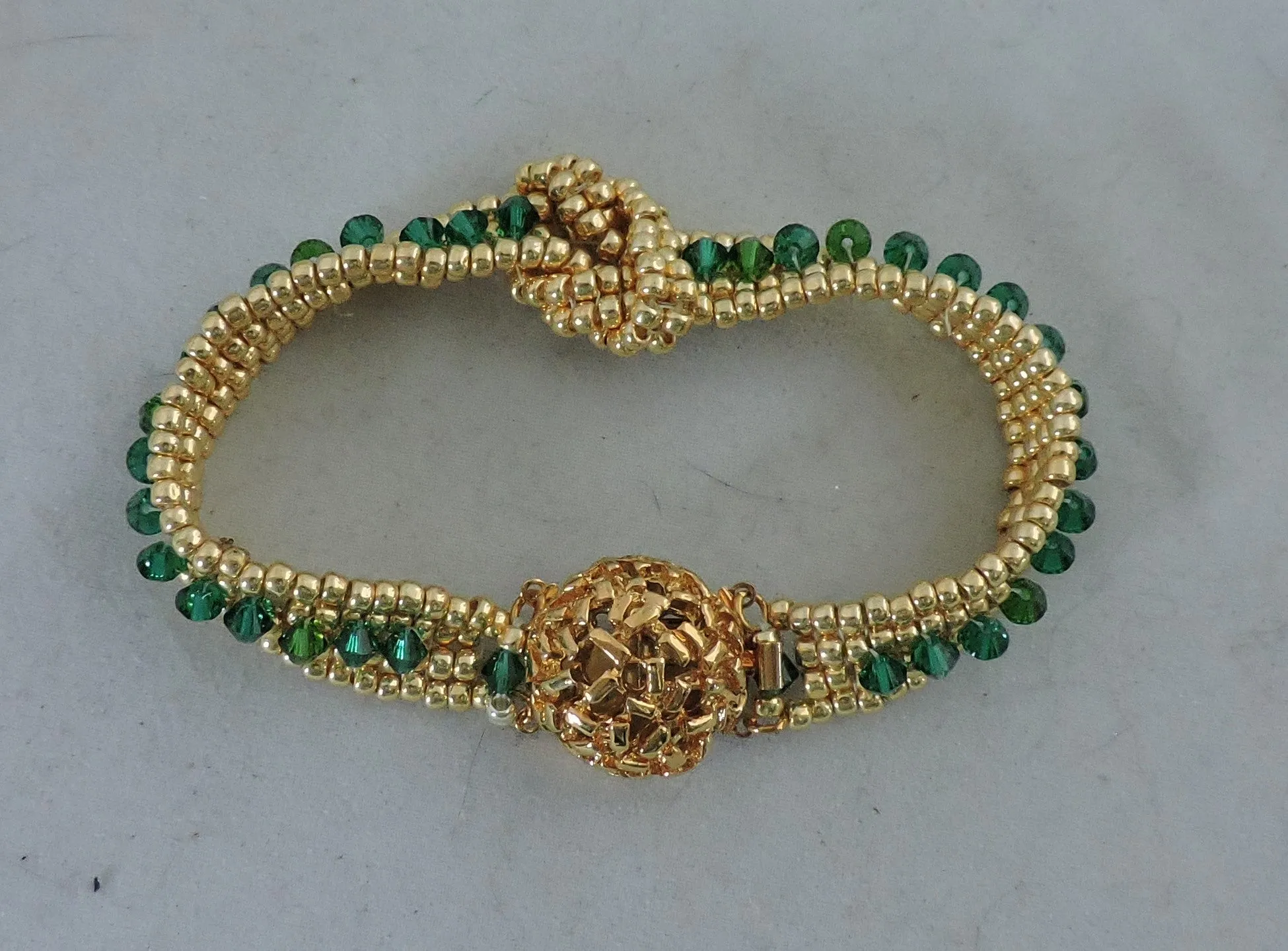 Bracelet with Swarovski Emerald Bicones and Gold Beads